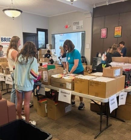 Volunteers fill backpacks for the Christ Child Society of Summit’s annual School Supplies Drive.