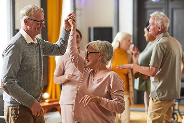 Illustrative photo of older adults dancing; not identified as a Gathering Place event.